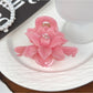 Top view of beige lotus shaped hair claw clip with petal details
