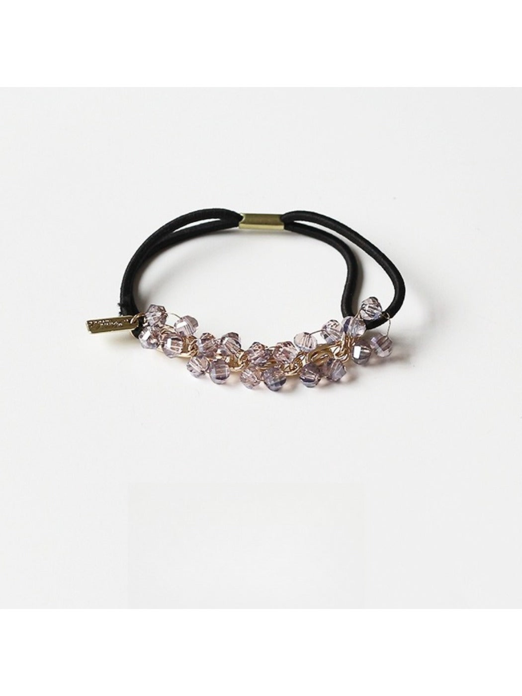 Gifty beaded hair tie stretched to show elasticity and bead details