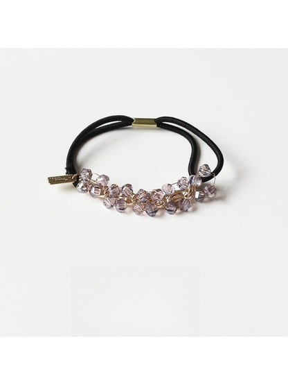 Gifty beaded hair tie stretched to show elasticity and bead details