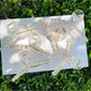 Beau flower crisscross hair claw clip in beige on white background