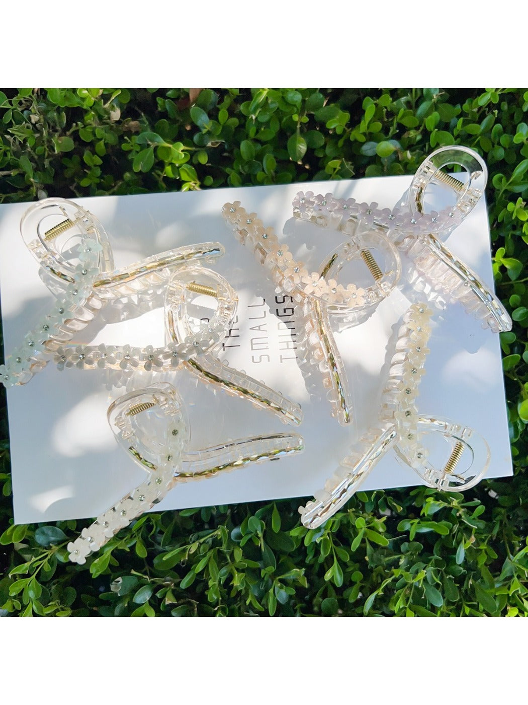 Beau flower crisscross hair claw clip in beige on white background