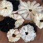 Close-up of Gifty delicate lace scrunchie in soft beige fabric