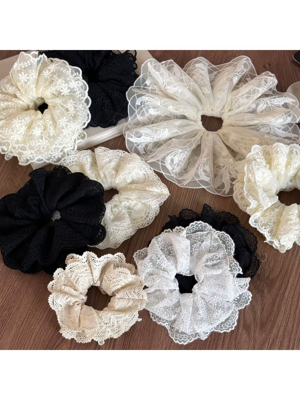Close-up of Gifty delicate lace scrunchie in soft beige fabric