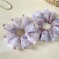 Side view of Gifty purple scrunchie highlighting gathered fabric design