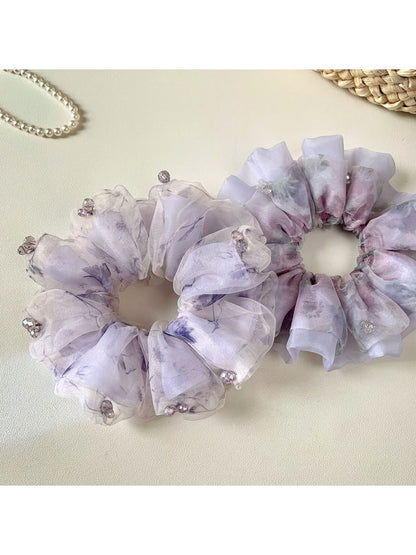 Side view of Gifty purple scrunchie highlighting gathered fabric design