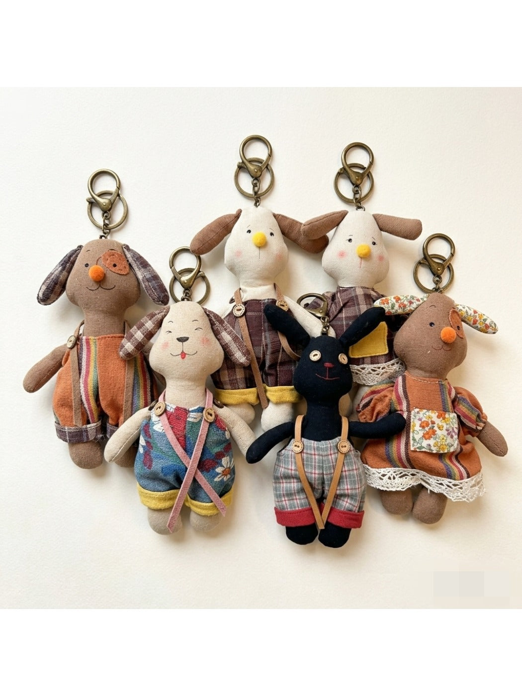 Close-up of the puppy-shaped fabric keychain showing textured fabric and embroidered eyes