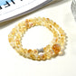 Close-up of Lovra yellow crystal beads and gold accents on multi-wrap bracelet
