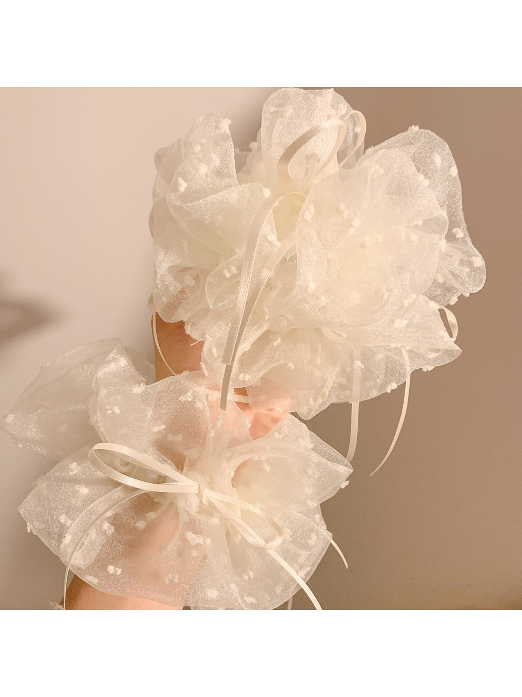 White double layer scrunchie styled on a wrist as a fashion accessory