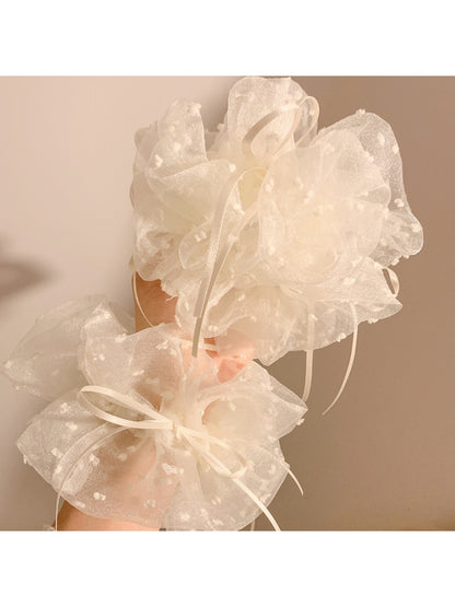 White double layer scrunchie styled on a wrist as a fashion accessory