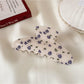 Beau hair claw clip angled to show both printed design and clip teeth