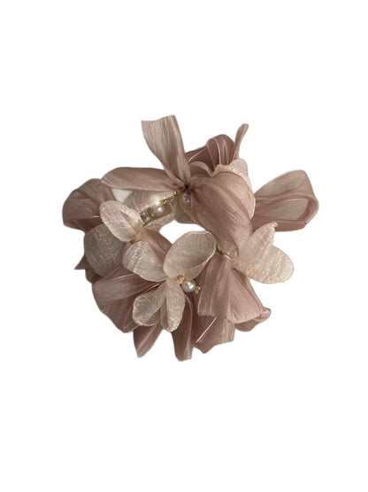 Close-up of the pink bow detail on the Gifty scrunchie showing fabric texture