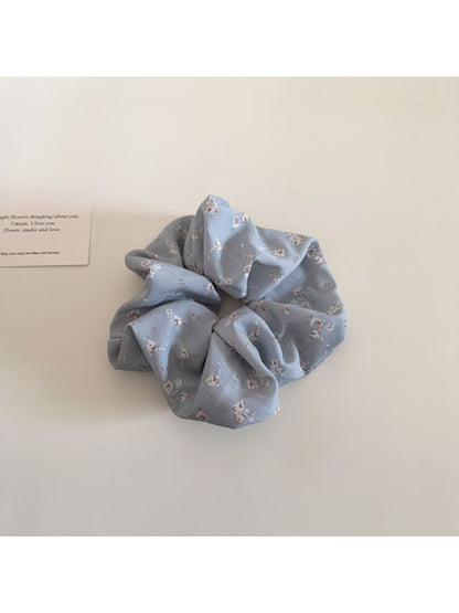 Multiple Gifty scrunchies stacked to show pattern and fabric details