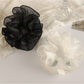 Close-up of Gifty minimalist double layer ruffled scrunchie in soft pink fabric