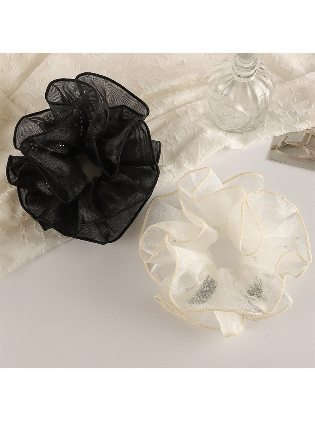 Close-up of Gifty minimalist double layer ruffled scrunchie in soft pink fabric