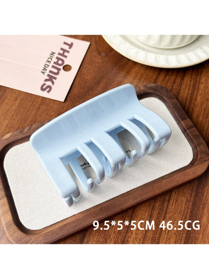 Beau plastic square claw clip held in hand for size reference