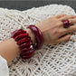 Close-up of Lovra red ombre link bracelet showing gradient color and texture