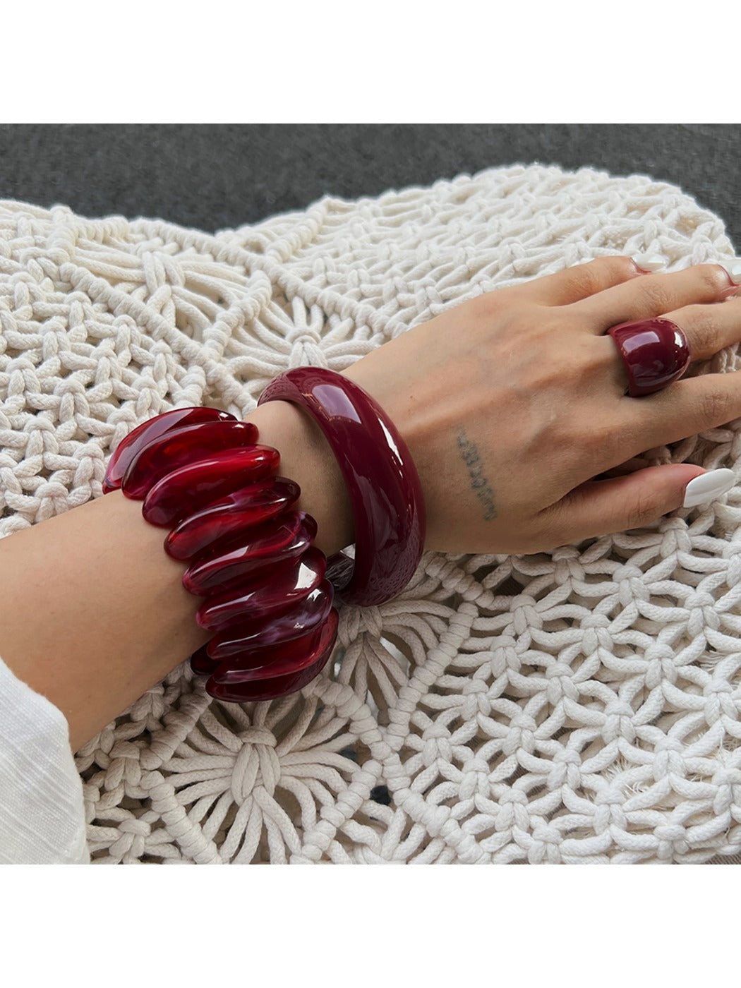 Close-up of Lovra red ombre link bracelet showing gradient color and texture