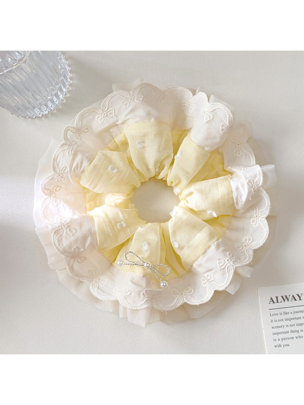 Gifty polka dot scrunchie displayed on a wooden surface showing fabric texture