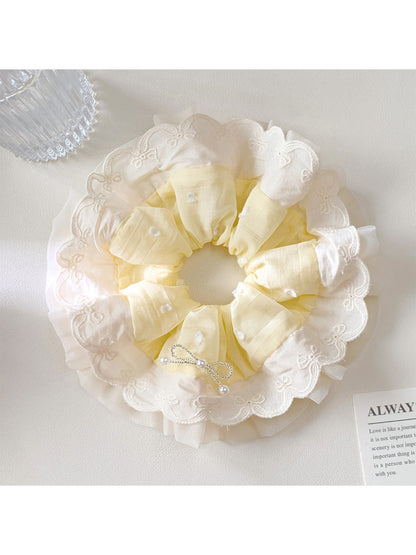 Gifty polka dot scrunchie displayed on a wooden surface showing fabric texture