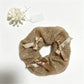 Gifty satin bow lace scrunchie styled with casual outfit on a wooden surface