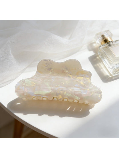 Top view of iridescent Beau mermaid claw clip with shimmering surface