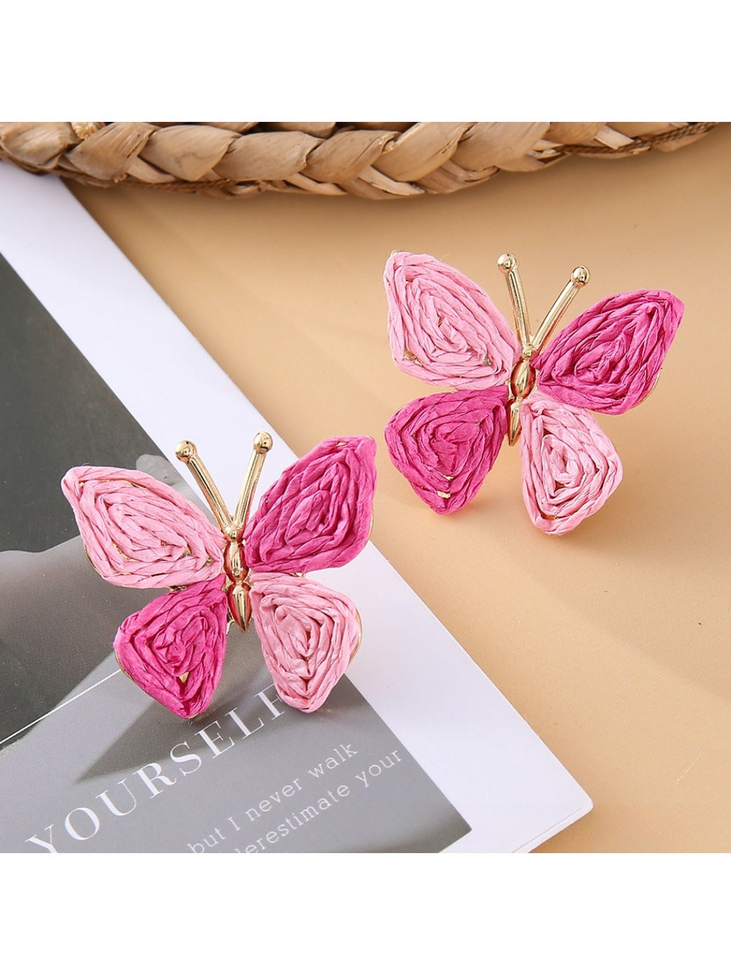 Close-up of butterfly earring detail showing smooth metal finish