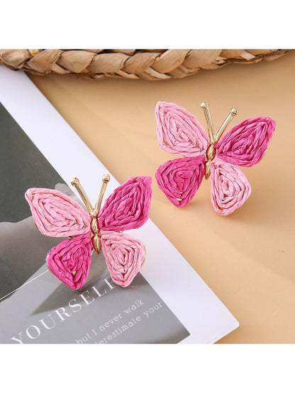 Close-up of butterfly earring detail showing smooth metal finish