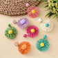Pair of raffia sunflower earrings displayed on a white background