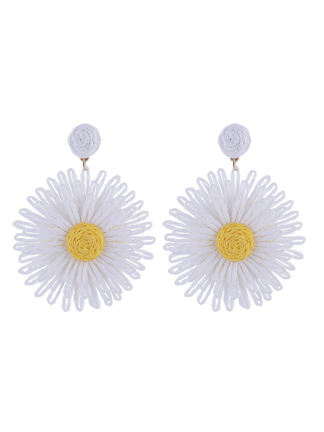 Colorful floral raffia earrings placed next to green leaves for styling