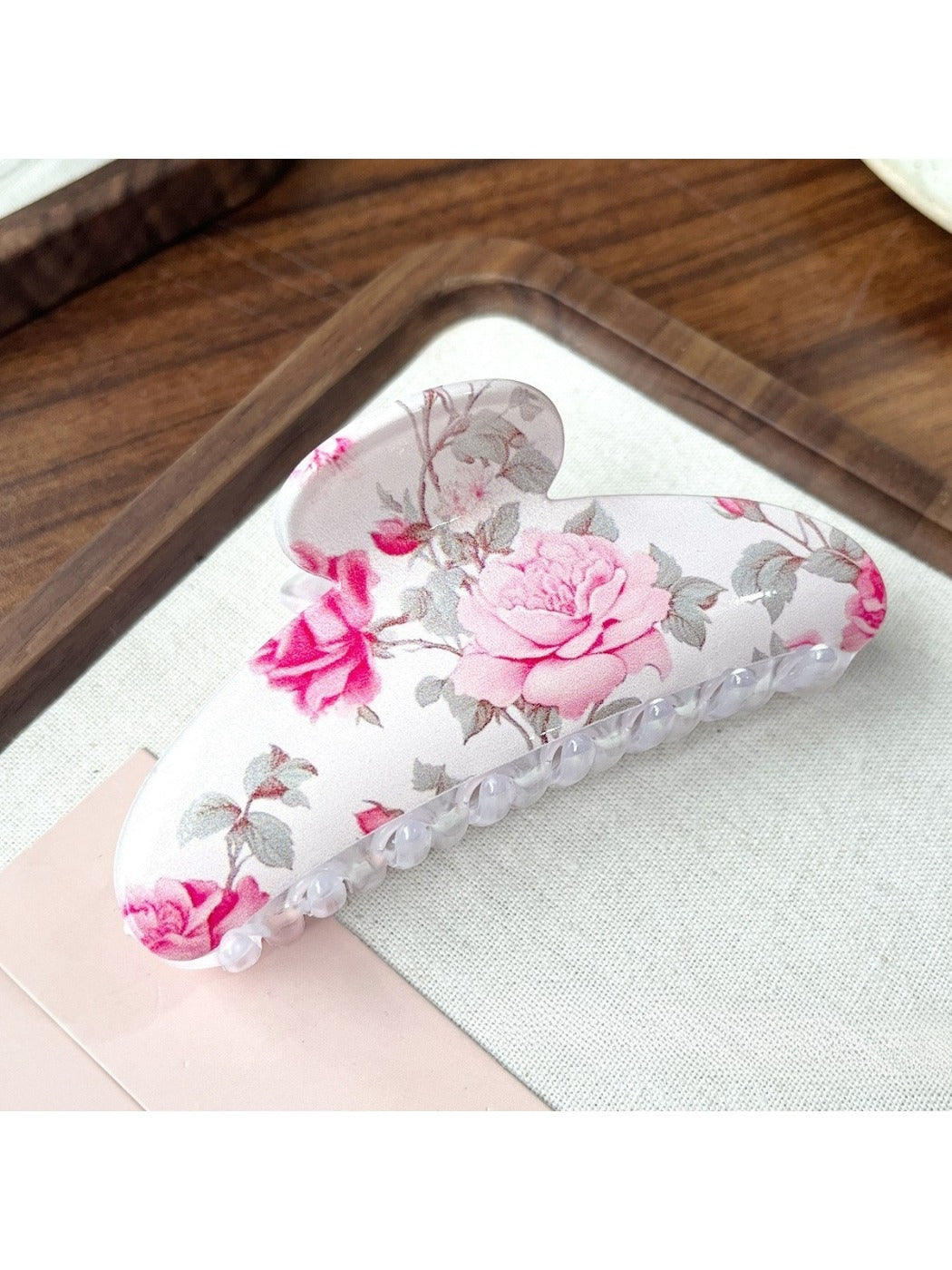 Side view of Beau hair clip highlighting detailed flower pattern and clip mechanism