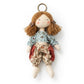 Fabric yarn doll keychain attached to a backpack zipper pull