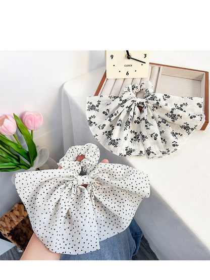 Gifty scrunchie styled in a ponytail with vintage floral pattern