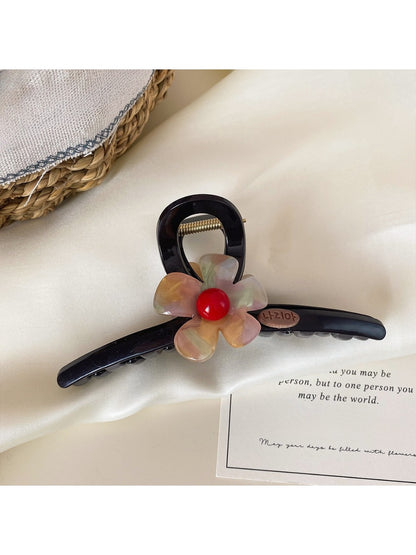 Beau claw clip worn in hair, showcasing size and floral design