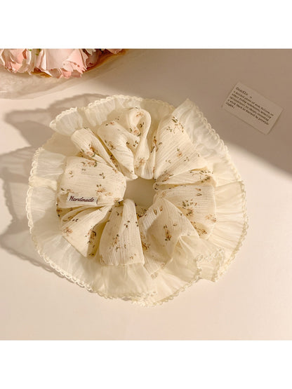 Gifty scrunchie in vintage floral print wrapped around a ponytail