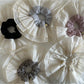 Close-up of beige lace scrunchie showing delicate double layer texture
