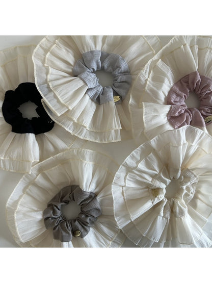 Close-up of beige lace scrunchie showing delicate double layer texture
