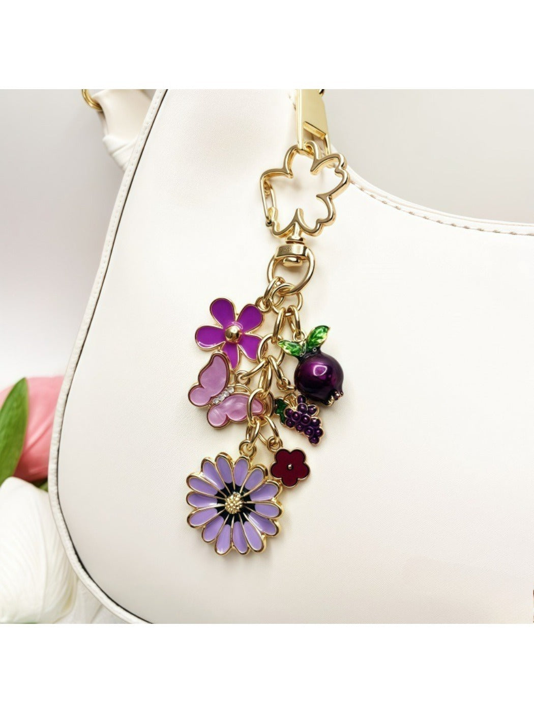 Daisy charm keychain attached to a set of keys on a wooden surface