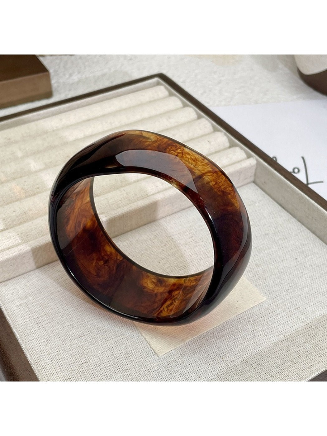 Multiple Lovra ombre bangles stacked on wrist with vintage irregular shapes