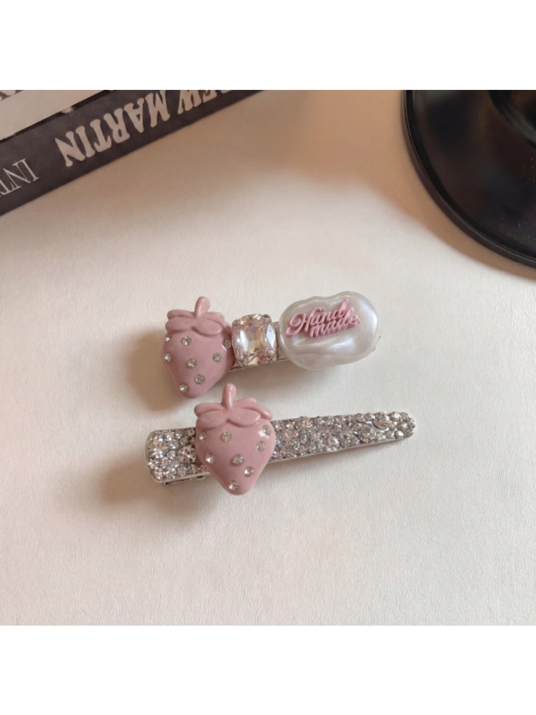 Beau hair clip worn in blonde hair showing the strawberry detail and gold clip base