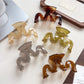 Close-up of Beau wave-shaped hair claw clip showing smooth matte finish