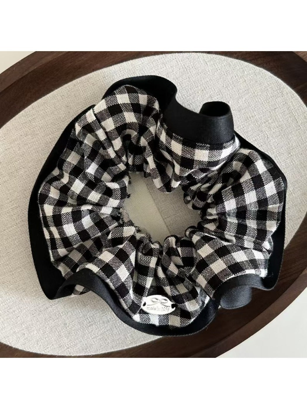 Black and white check scrunchie styled in a ponytail on a model