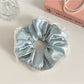 Side view of Gifty satin tulle ruffled scrunchie highlighting texture and volume