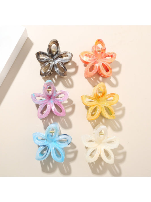 Beau colorful flower-shaped hair clip with openwork design on white background
