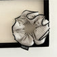 Gifty scrunchie held in hand showing size and stretchiness of fabric