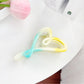 Beau heart shaped claw clip open to show spring mechanism and claw teeth