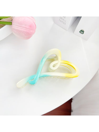 Beau heart shaped claw clip open to show spring mechanism and claw teeth