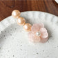 Top view of Beau Camellia shaped hair clip with intricate bead design