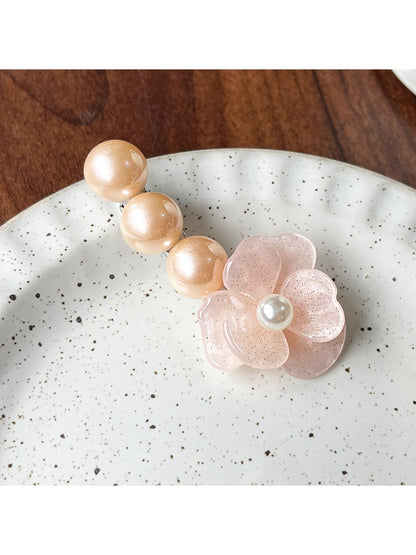 Top view of Beau Camellia shaped hair clip with intricate bead design