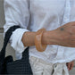 Detailed shot of Lovra bracelet's smooth metal surface and irregular shape