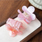 Beau floral claw clip open to display metal spring mechanism and flower details
